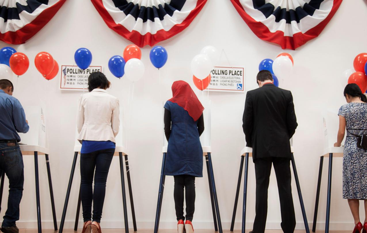 Five people at the voting boxes