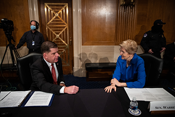 Labor secretary nominee Marty Walsh speaks with Senator Elizabeth Warren (D-MA) at his confirmation hearing.